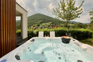 a jacuzzi tub with a view of a mountain at Mobile Homes Camping Plitvice in Smoljanac