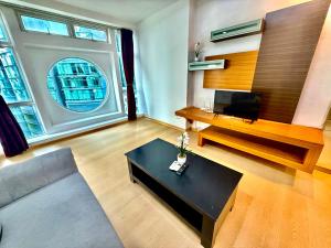 a living room with a couch and a tv at Parkview Suites Near By Klcc in Kuala Lumpur