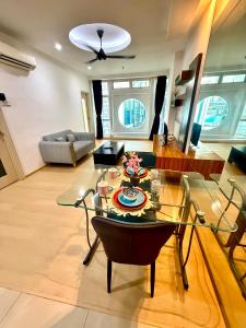 a living room with a glass table and a couch at Parkview Suites Near By Klcc in Kuala Lumpur