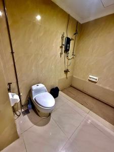 a bathroom with a toilet and a phone on the wall at Parkview Suites Near By Klcc in Kuala Lumpur +8 photos