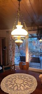 a chandelier in a living room with a table at Józefowa Chata in Rudnik +23 photos