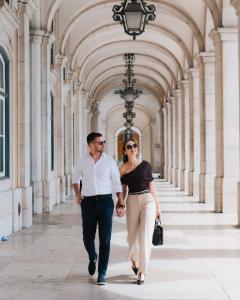 a man and a woman walking down a hallway at AlmaLusa Baixa/Chiado in Lisbon