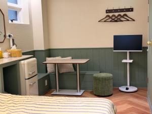 a room with a table and a tv in it at Casa olive 까사올리브 in Millak-tong +69 photos