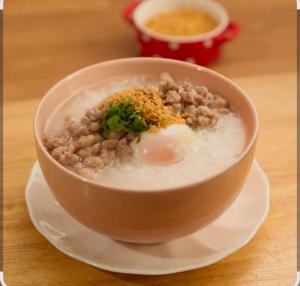 a bowl of soup on a plate on a table at BaanPhutawanLanta resort & cafe in Ko Lanta