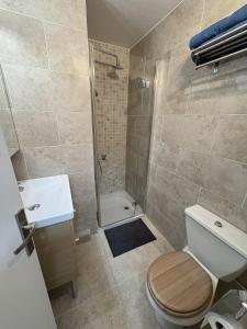 a bathroom with a toilet and a sink and a shower at Superbe studio terrasse piscine et plage in Fréjus +12 photos