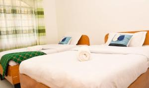 a row of beds in a room at Eldoville Home in Eldoret