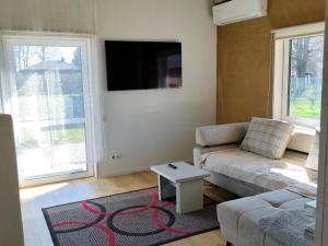 a living room with a couch and a table at Brīvdienu māja in Jelgava