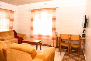 a living room with a couch and a table at Eldoville Home in Eldoret