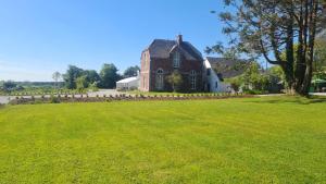 a large grass field in front of a house at Glenduff Manor in Glendiff
