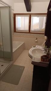 a bathroom with a sink and a shower and a tub at Appartamento Luigia House in Cornaredo