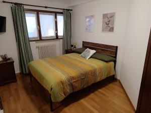 a bedroom with a bed and a window at Appartamento Luigia House in Cornaredo +5 photos