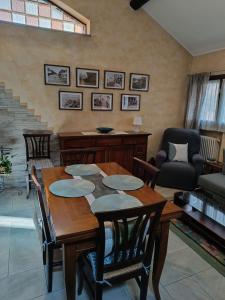 a living room with a wooden table and chairs at Appartamento Luigia House in Cornaredo