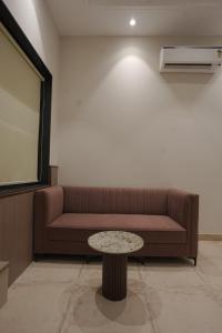a living room with a couch and a table at Damru in Jaipur