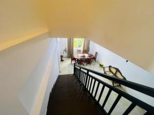 an overhead view of a staircase with a table and chairs at Emerald Leaf Kandy Villa in Panabokka