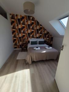 a bedroom with a large bed in a attic at l'imprimerie in Malestroit