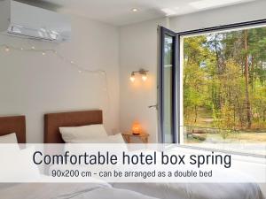 a hotel room with a bed and a window at Baham-Apartment Nuernberg - including hot tub, sauna, massage chair, roof terrace, barbecue - metro 15 min, exhibition center 8 min walk in Nuremberg