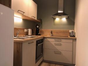 a kitchen with a sink and a stove top oven at l'imprimerie in Malestroit