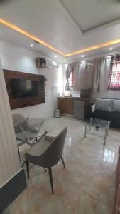 a living room with two chairs and a couch at Cheers Guesthouse in Botianaw