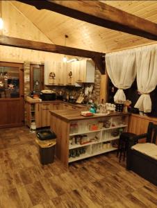 a kitchen with a island in the middle of a room at Poienița Lupului in Vărbilău