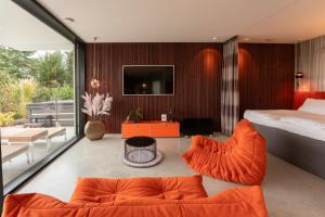 a bedroom with a bed and a living room at ORANGE LOUNGE Attersee in Weyregg