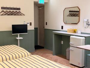 a hospital room with a bed and a desk at Casa olive 까사올리브 in Millak-tong