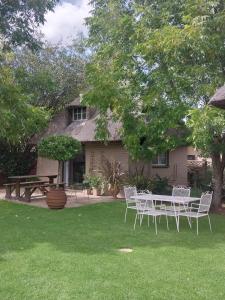a table and chairs in front of a house at Harmony and Melody self catering in Bethlehem