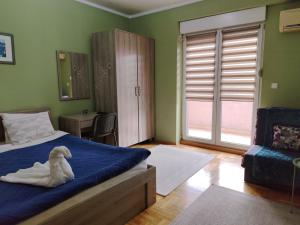 a bedroom with a bed with a stuffed animal on it at Apartment Temple in Podgorica