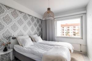 a bedroom with two beds and a window at Nordic Nook By Elys Collection in Rovaniemi