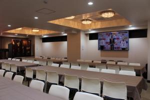 a conference room with tables and chairs and a projection screen at Art Five Hotel BOIS博多 in Fukuoka +12 photos