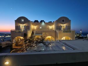a view from the roof of a building at night at Kiklamino Sunset Suites in Oia