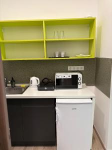 a kitchen with a sink and a microwave on a counter at Tisza Garden Park in Tiszalök +35 photos