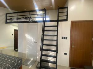 a bunk bed in a room with a spiral staircase at Balai Mi Vigan in Vigan