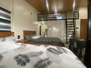 a bedroom with two beds and a bunk bed at Balai Mi Vigan in Vigan