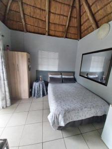 a bedroom with a bed and a table in it at Harmony and Melody self catering in Bethlehem