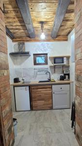 a kitchen with a sink and a counter at La Hotar in Buchin