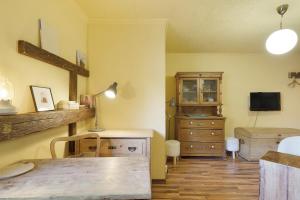 a room with a table and a dresser and a television at Romantikzimmer in Striesen in Dresden +6 photos