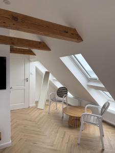 a living room with skylights and a table and chairs at Enklawa - Floryn Mielno in Mielno