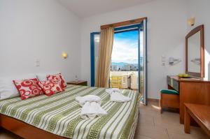a bedroom with a bed and a window with a view at Magic Summer in Agia Anna Naxos