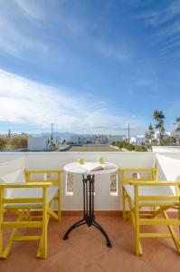 a table and chairs on a balcony with a view at Magic Summer in Agia Anna Naxos