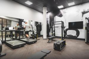 a room with a gym with people exercising in it at The Capital Boardwalk in Gqeberha