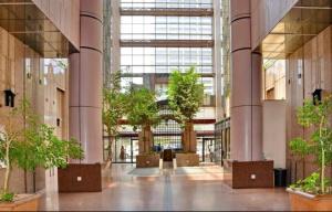 a large lobby with trees in a building at High Rise Haven 2 in Johannesburg