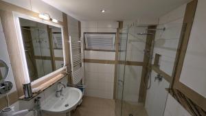 a bathroom with a sink and a shower at Villa Müsli in Dettingen an der Iller +3 photos