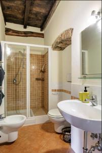 a bathroom with a shower and a toilet and a sink at Villa Toscanna in Pelago +40 photos