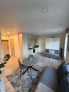 a living room with a table and a couch at Kaunas City Center Apartment in Kaunas