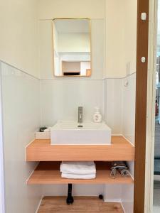 a bathroom with a sink and a mirror at 十五夜 in Osaka +7 photos