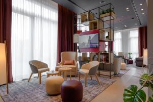 a living room with chairs and a table at IntercityHotel Herford in Herford +27 photos