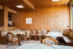a dining room with wooden walls and tables and chairs at Hotel Garni Zielinski in Sindelfingen