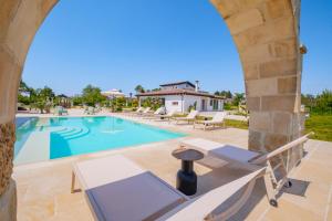 a villa with a swimming pool and a resort at Villa Kalia Luxury by HDSalento in Aradeo