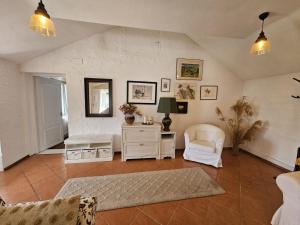 a living room with two chairs and a table at Guest House Luca in Galda de Jos