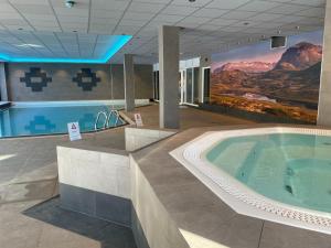 a large hot tub in a building with a mountain mural at Actif 305 Apartment by Ål Ski Center in Al